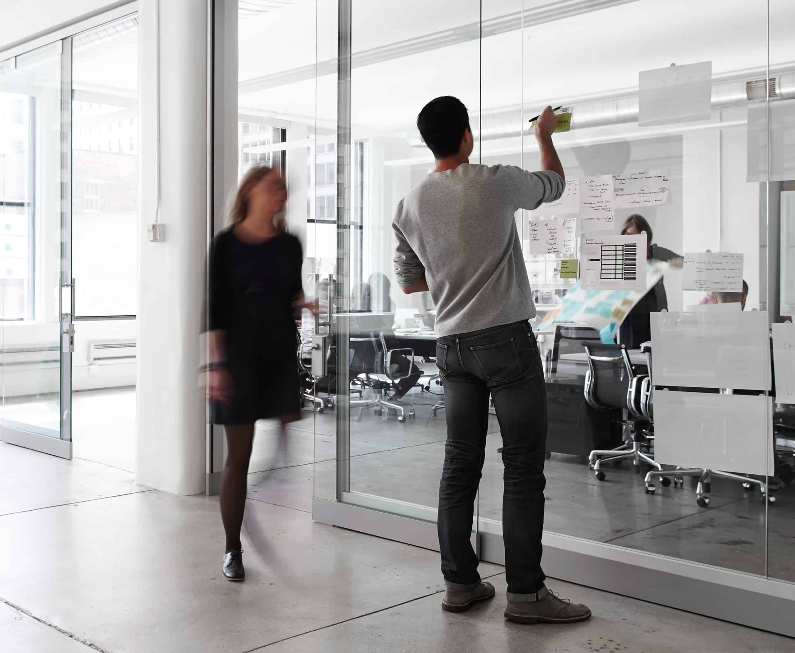 Ia Workspace Team Writing Sticky Notes On Glass Wall