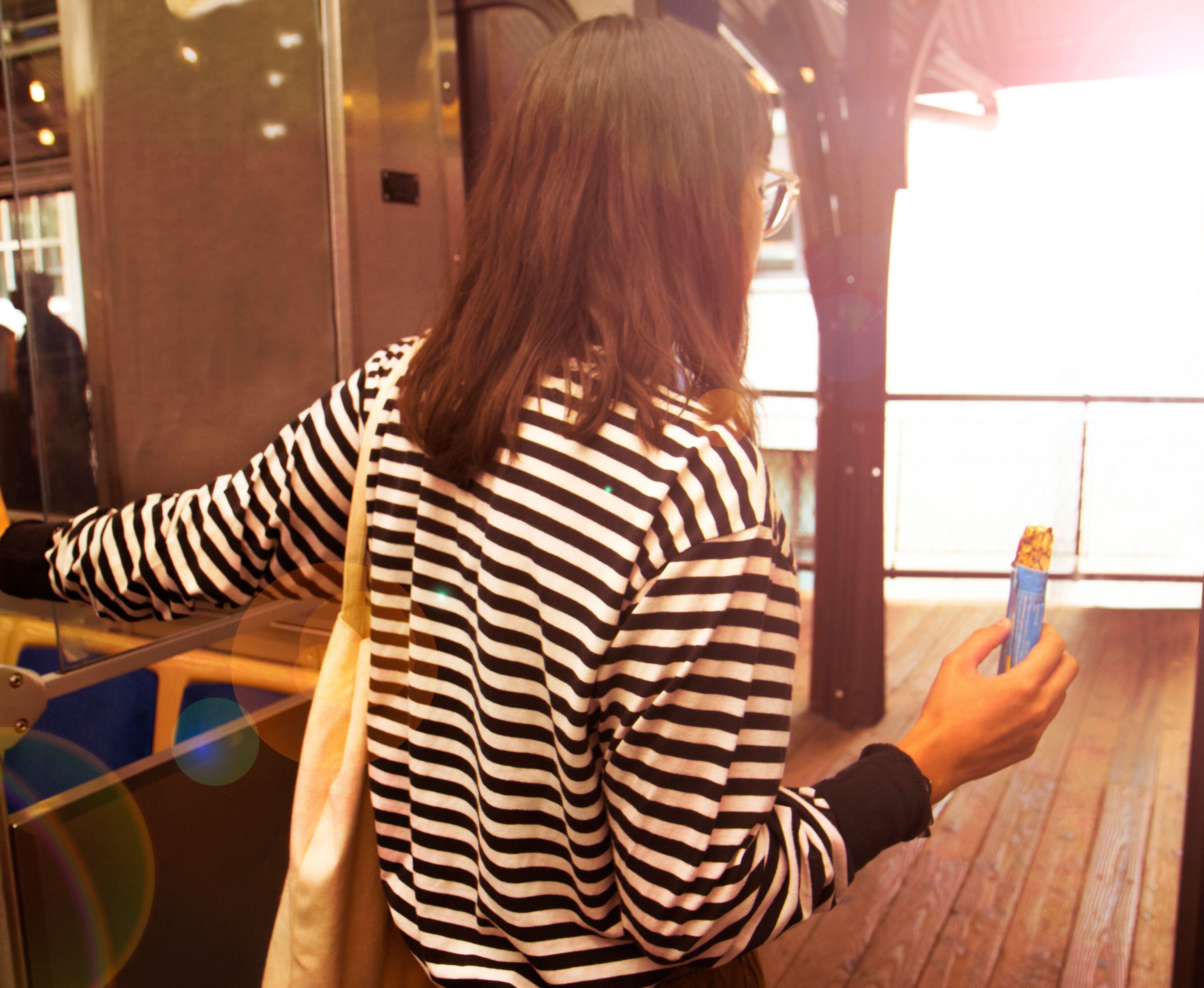 Quaker Init Woman Holding Snack Bar On Transit